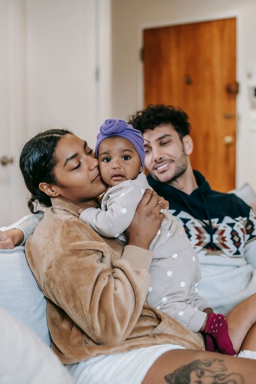 Parents and their toddler sharing a quiet moment at home